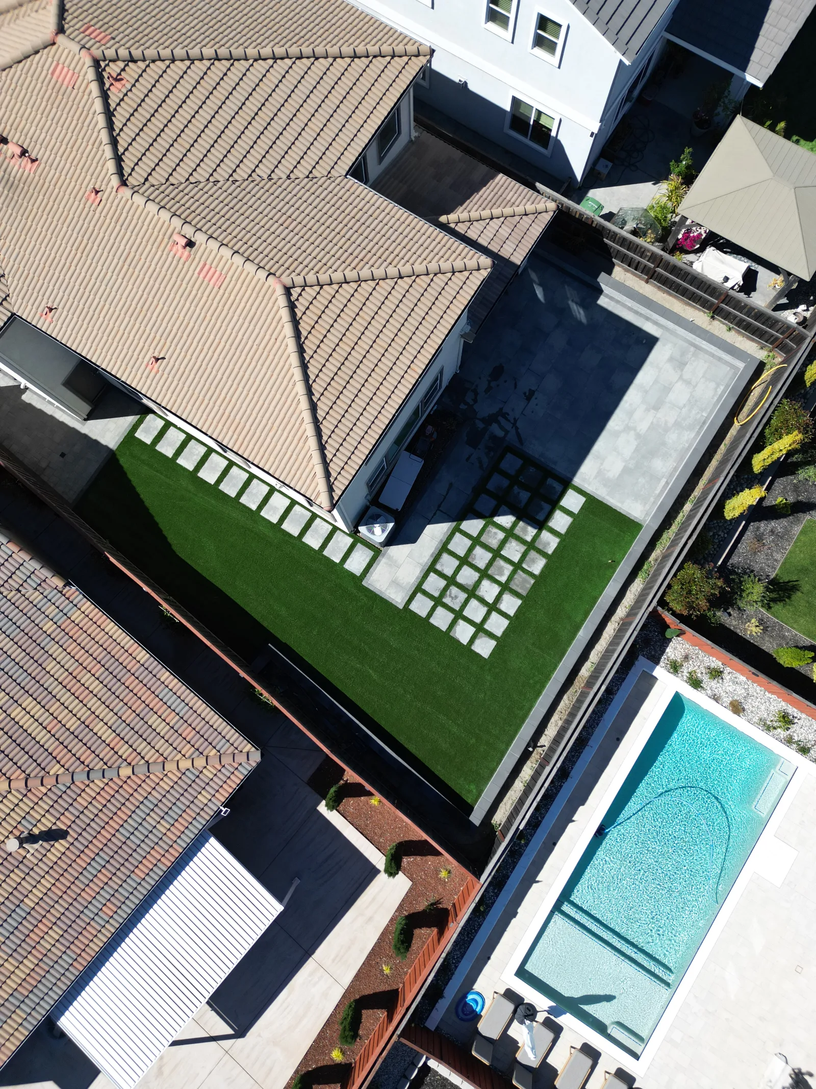 Close aerial view of artificial turf with paver grid checkerboard and patio in Fairfield, CA